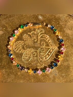 New Unworn multicoloured crystal bracelet, gold plate.